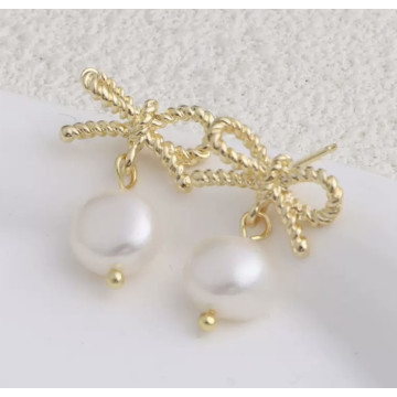 Gold bow studs with natural...